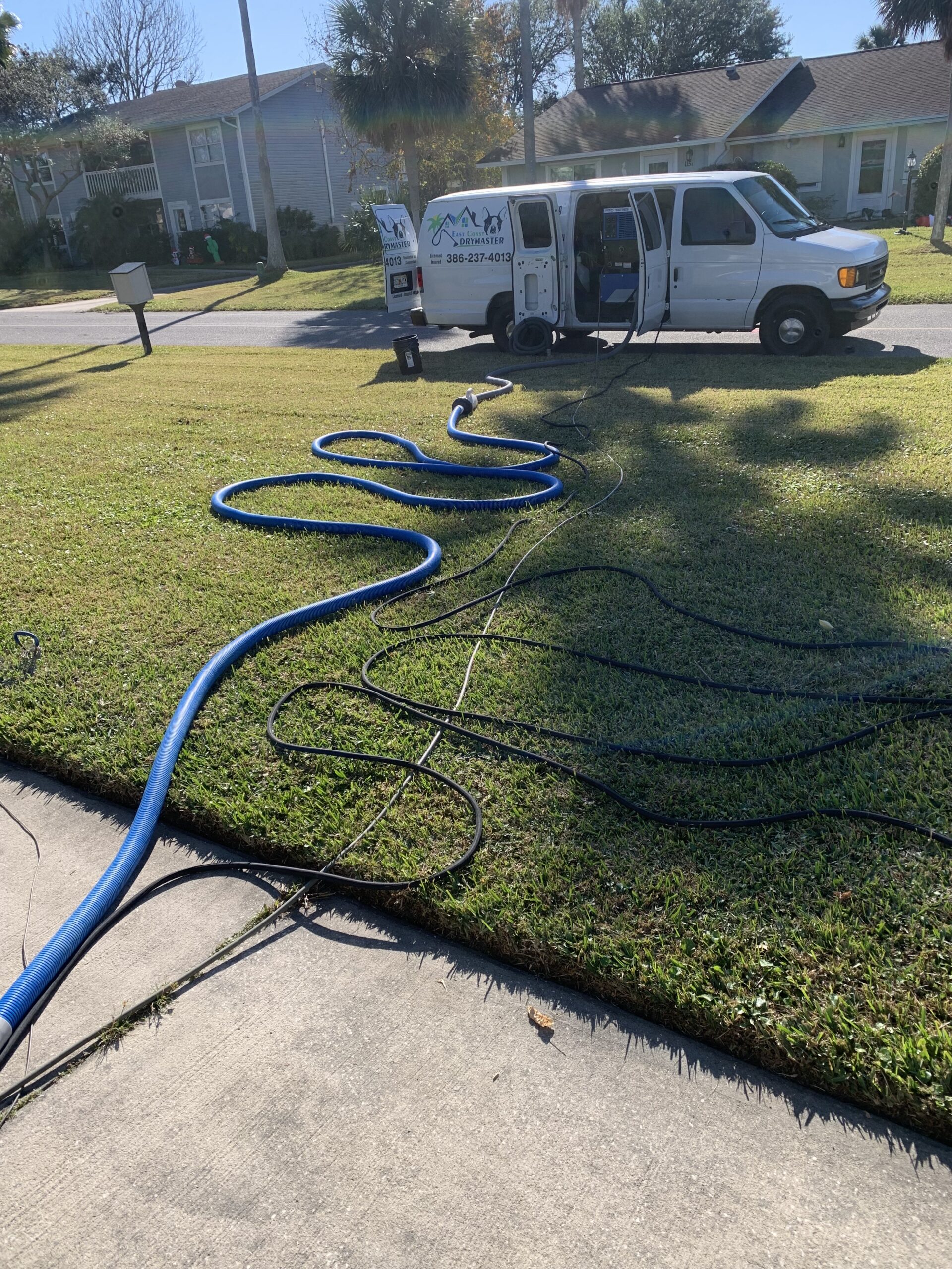 East Coast Drymaster service van parked at client's home